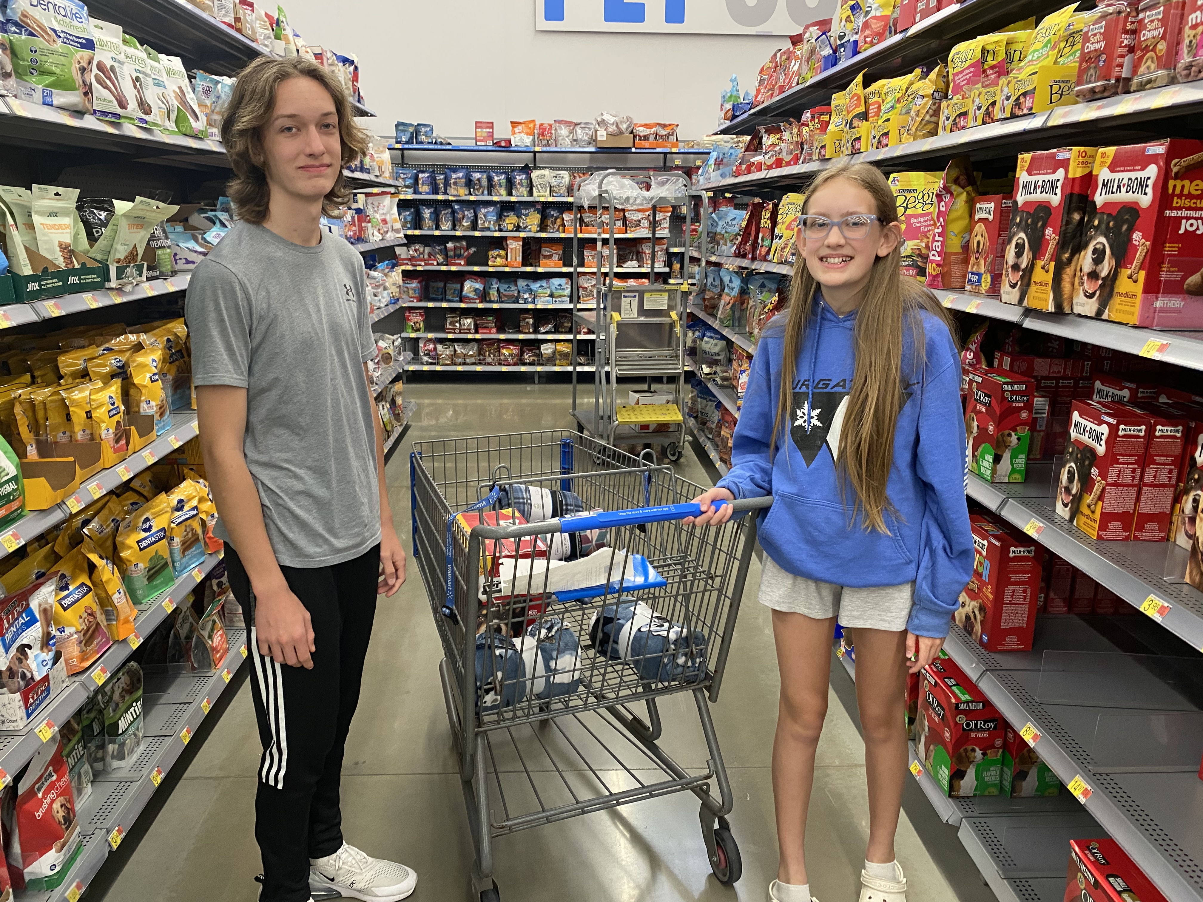 Lane and Brooke Hayes pose on pet aisle at store.